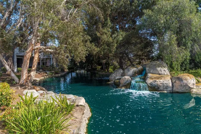 a backyard of a house with lots of green space table and chairs