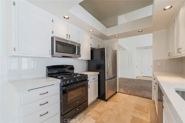 a kitchen with a sink stainless steel appliances and cabinets