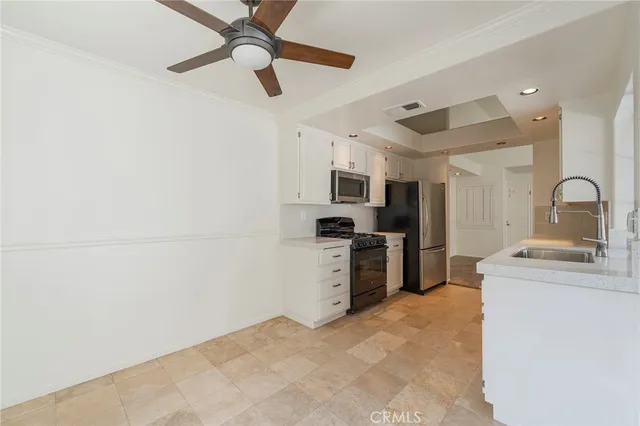 a kitchen with granite countertop a sink stainless steel appliances and cabinets