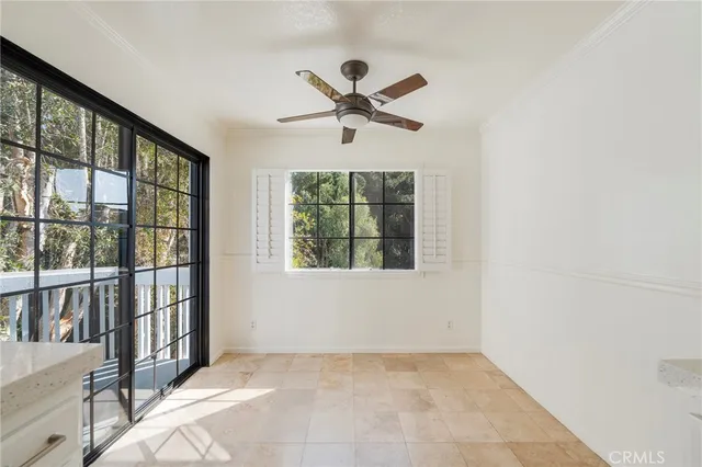 a view of a livingroom with a ceiling fan and a large window