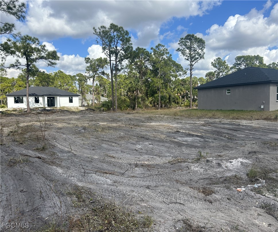 3404 72nd Street West Lehigh Acres, FL 33971 - Photo 2 of 2 a view of a house with a yard and a garage