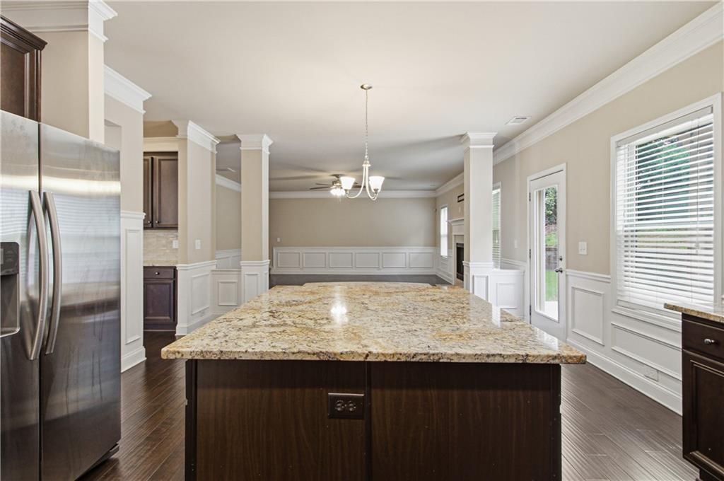 114 Madison Street Canton, GA 30115 - Photo 14 of 39 a kitchen with a center island and refrigerator