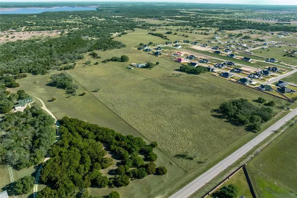 an aerial view of a residential houses with outdoor space