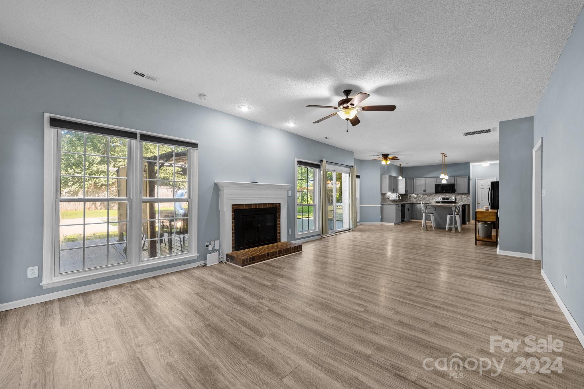 1041 Fairway Ridge Drive Northwest Concord, NC 28027 - Photo 11 of 44 a view of an empty room with furniture a fireplace and wooden floor