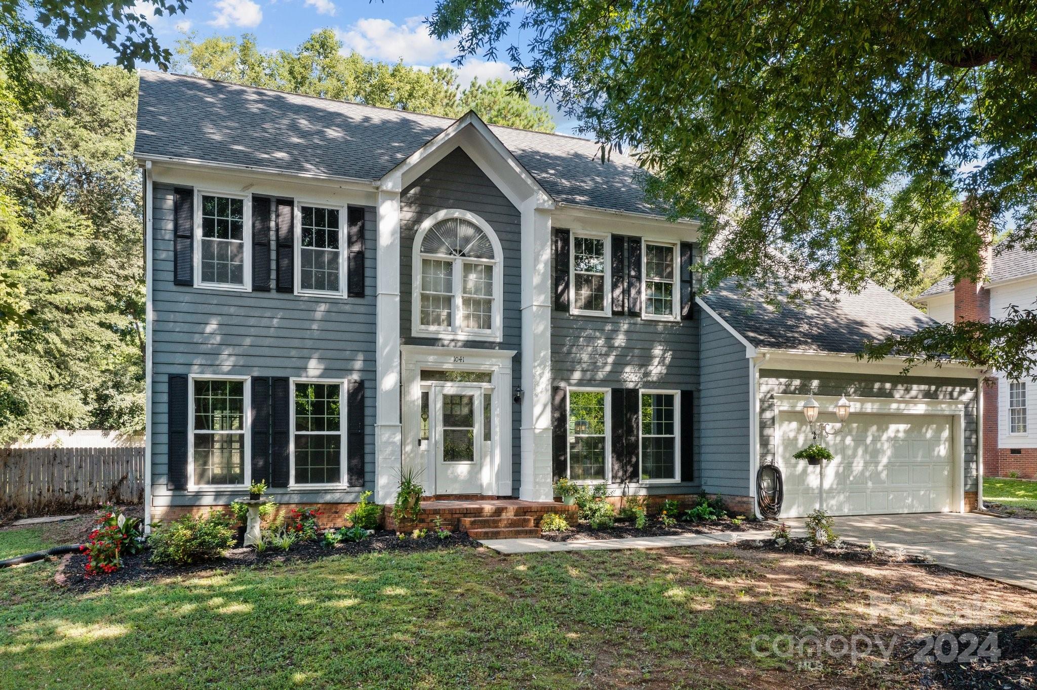 1041 Fairway Ridge Drive Northwest Concord, NC 28027 - Photo 2 of 44 a front view of a house with a yard