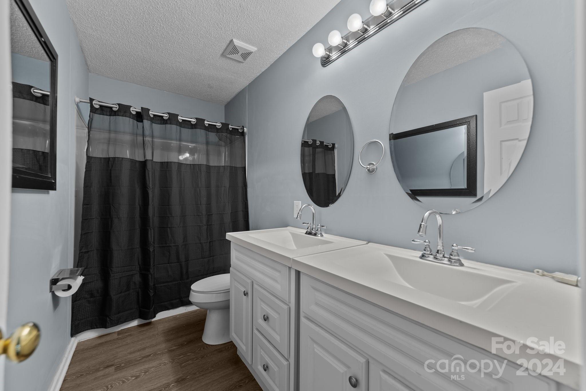 1041 Fairway Ridge Drive Northwest Concord, NC 28027 - Photo 31 of 44 a bathroom with a double vanity sink mirror and toilet