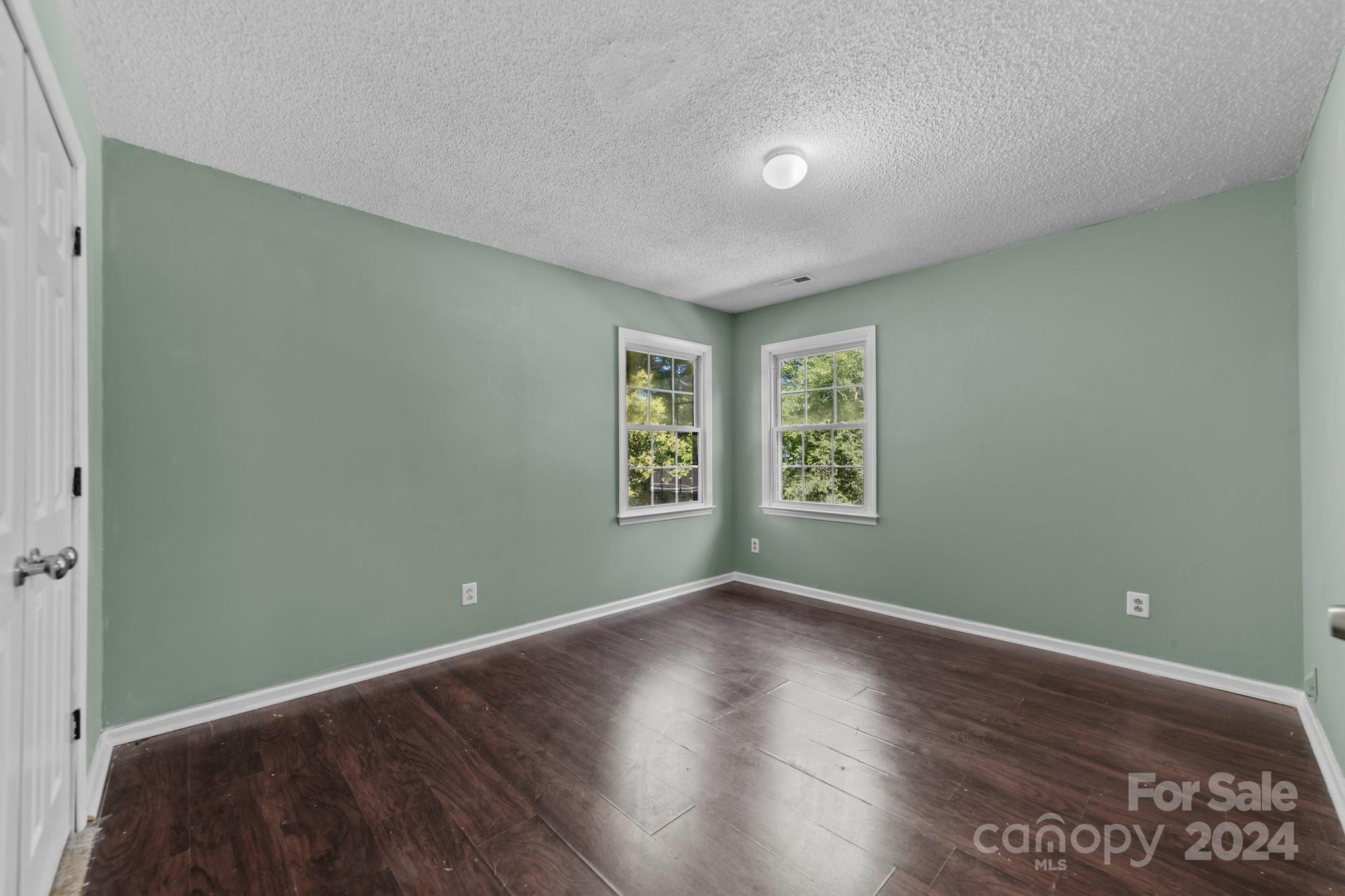 1041 Fairway Ridge Drive Northwest Concord, NC 28027 - Photo 32 of 44 an empty room with wooden floor and windows