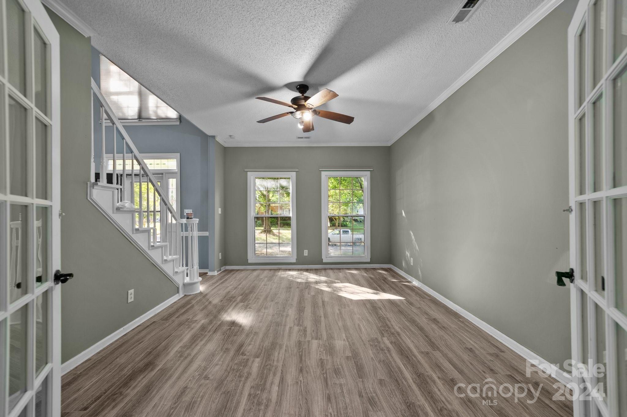 1041 Fairway Ridge Drive Northwest Concord, NC 28027 - Photo 6 of 44 a view of empty room with wooden floor and fan