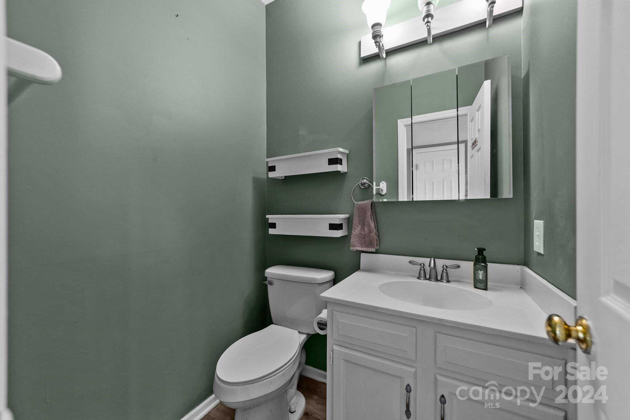 1041 Fairway Ridge Drive Northwest Concord, NC 28027 - Photo 9 of 44 a bathroom with a toilet sink and mirror