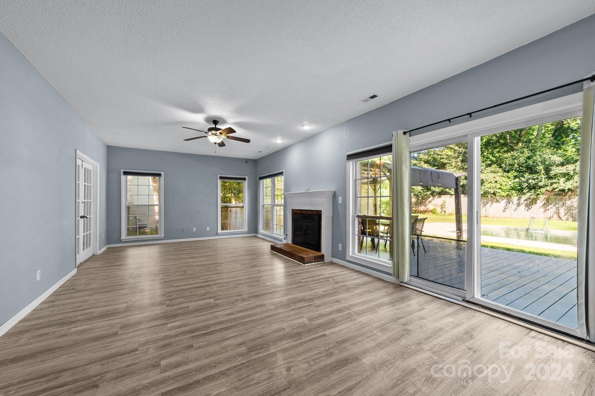 1041 Fairway Ridge Drive Northwest Concord, NC 28027 - Photo 10 of 44 a view of an empty room with wooden floor and a window