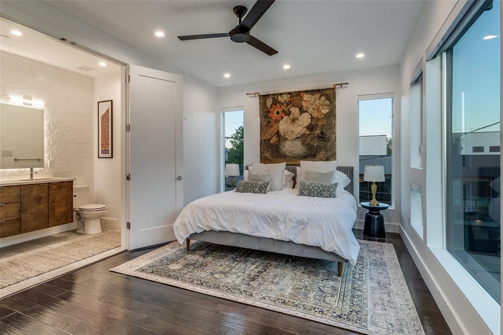 4805 Manett Street, Unit 101 Dallas, TX 75204 - Photo 12 of 18 a spacious bedroom with a bed a mirror and furniture