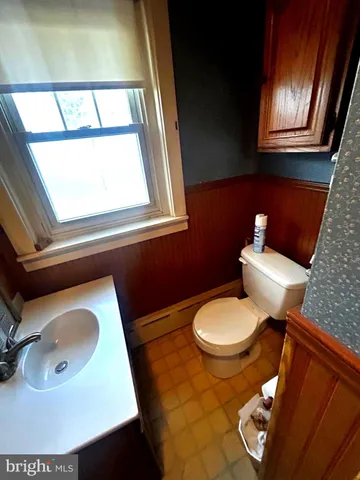 a bathroom with a toilet sink and mirror