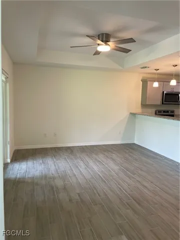 a view of a room with wooden floor