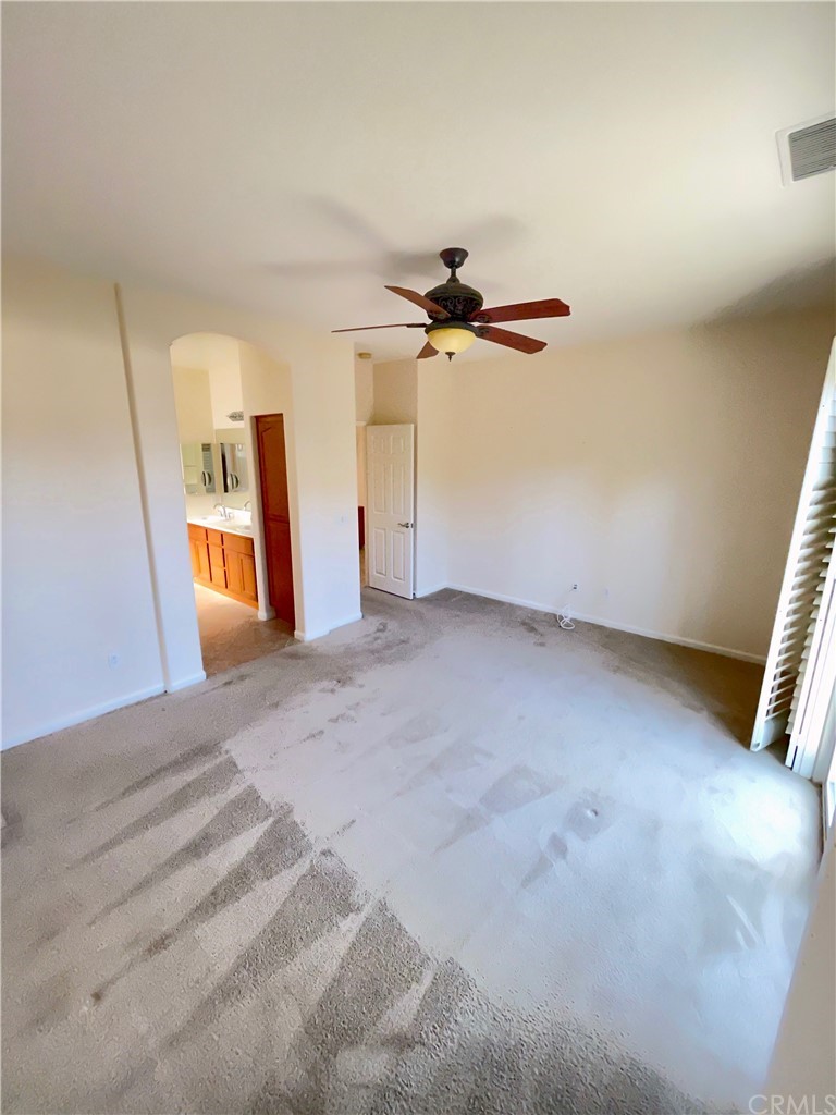 24042 Boulder Oaks Drive Corona, CA 92883 - Photo 5 of 8 a view of a livingroom with a ceiling fan