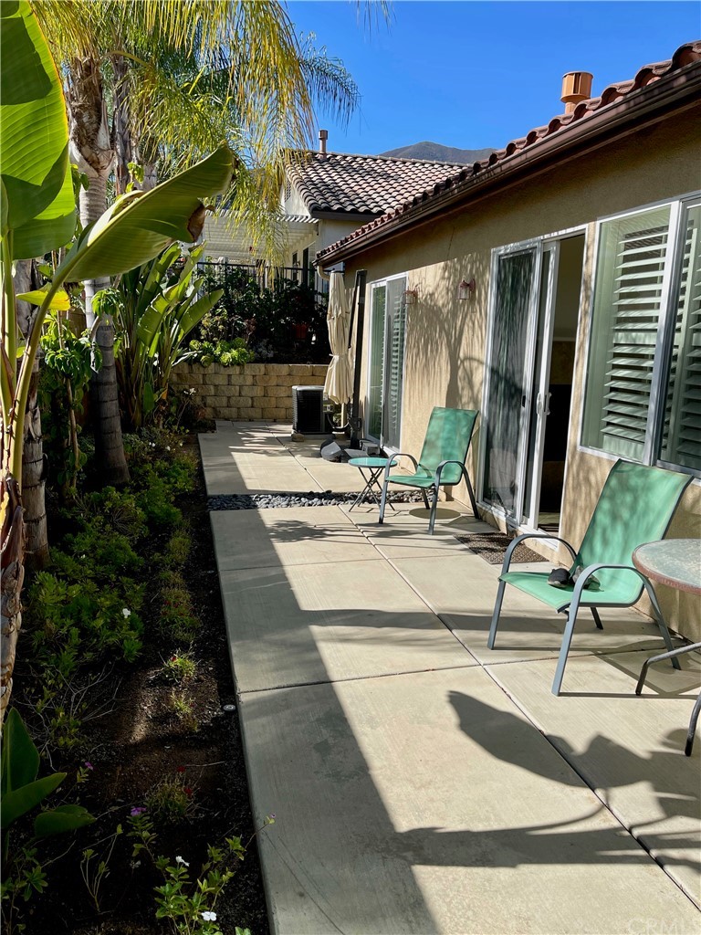 24042 Boulder Oaks Drive Corona, CA 92883 - Photo 8 of 8 a view of house with backyard and glass windows