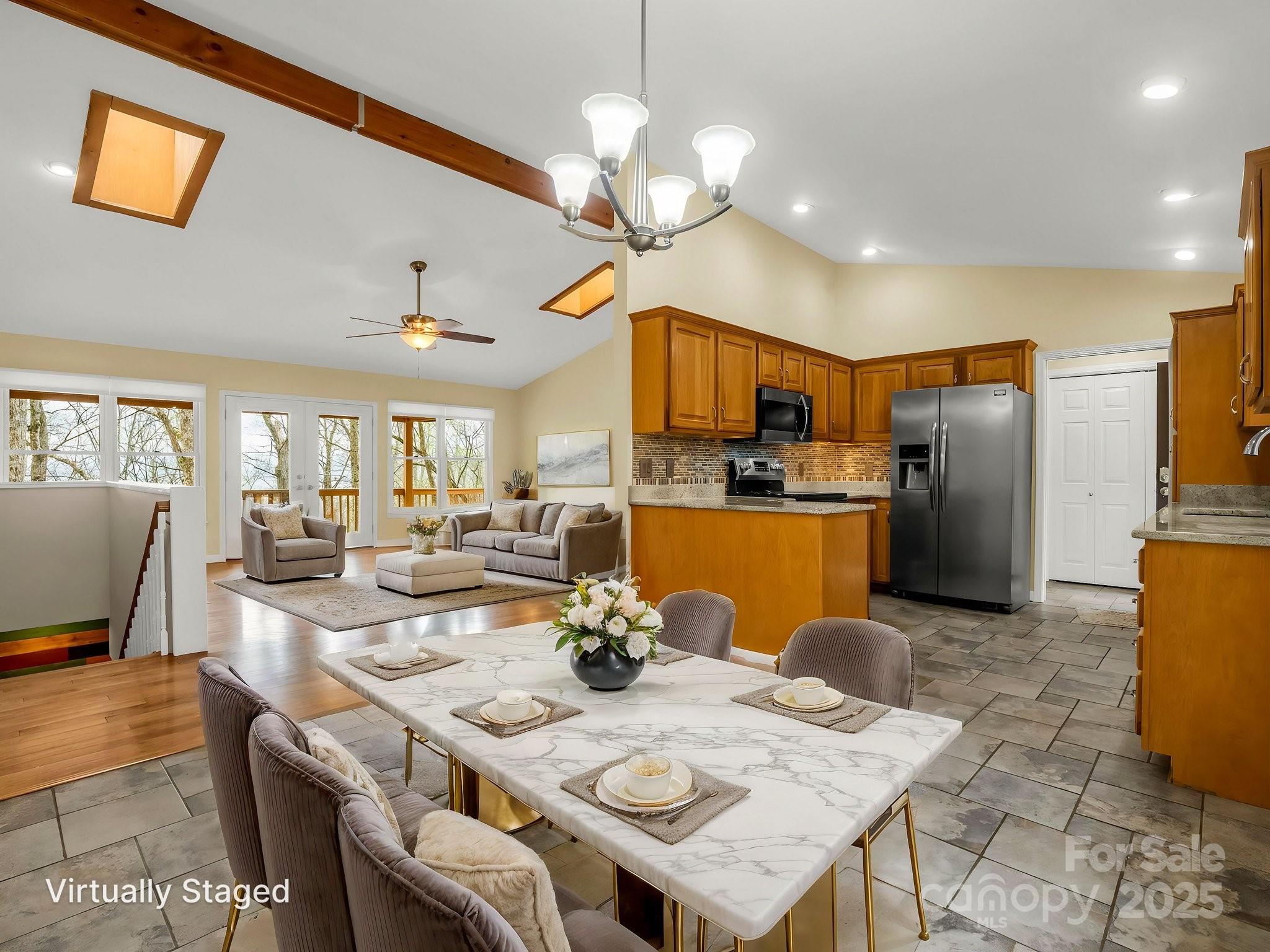 1116 High Vista Drive Mills River, NC 28759 - Photo 11 of 40 a kitchen with stainless steel appliances granite countertop a dining table chairs refrigerator and microwave