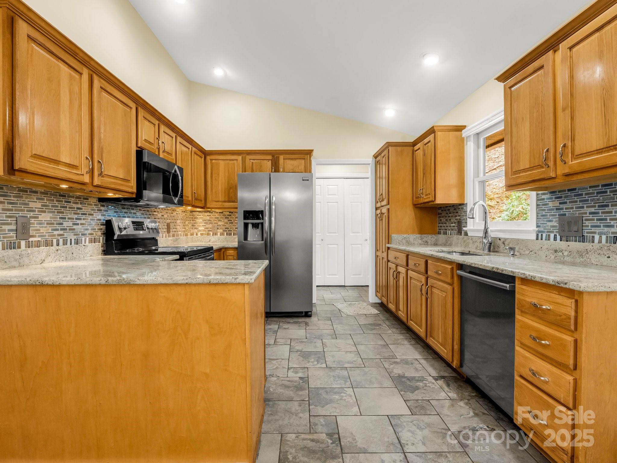 1116 High Vista Drive Mills River, NC 28759 - Photo 14 of 40 a large kitchen with stainless steel appliances granite countertop a stove a sink dishwasher a refrigerator and cabinets with wooden floor