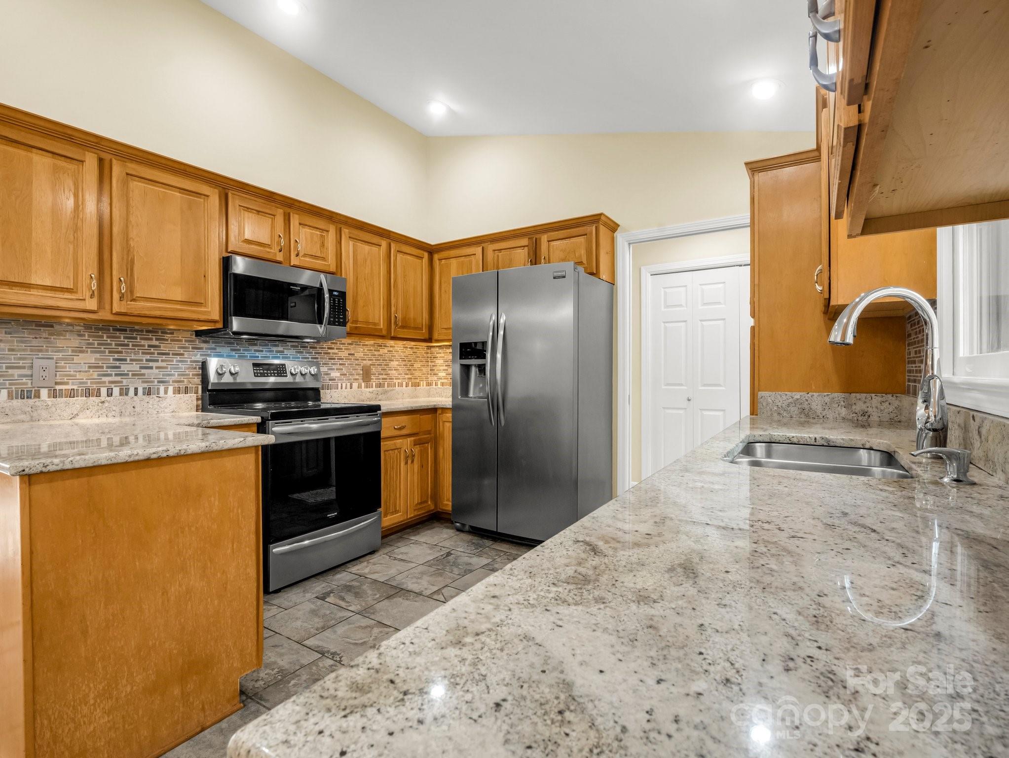 1116 High Vista Drive Mills River, NC 28759 - Photo 15 of 40 a kitchen with stainless steel appliances granite countertop a refrigerator sink and stove