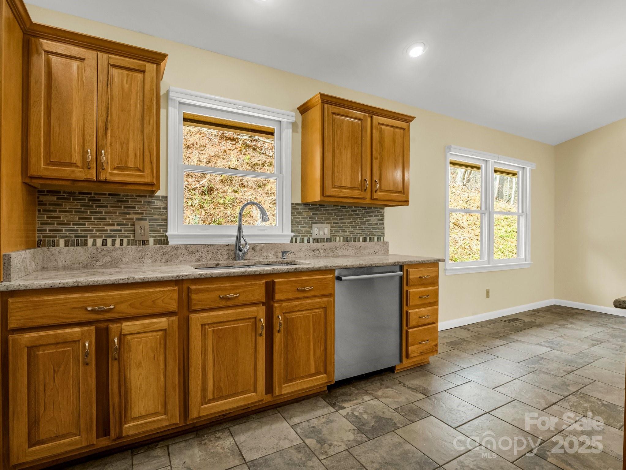 1116 High Vista Drive Mills River, NC 28759 - Photo 16 of 40 a kitchen with granite countertop a sink cabinets stainless steel appliances and a window
