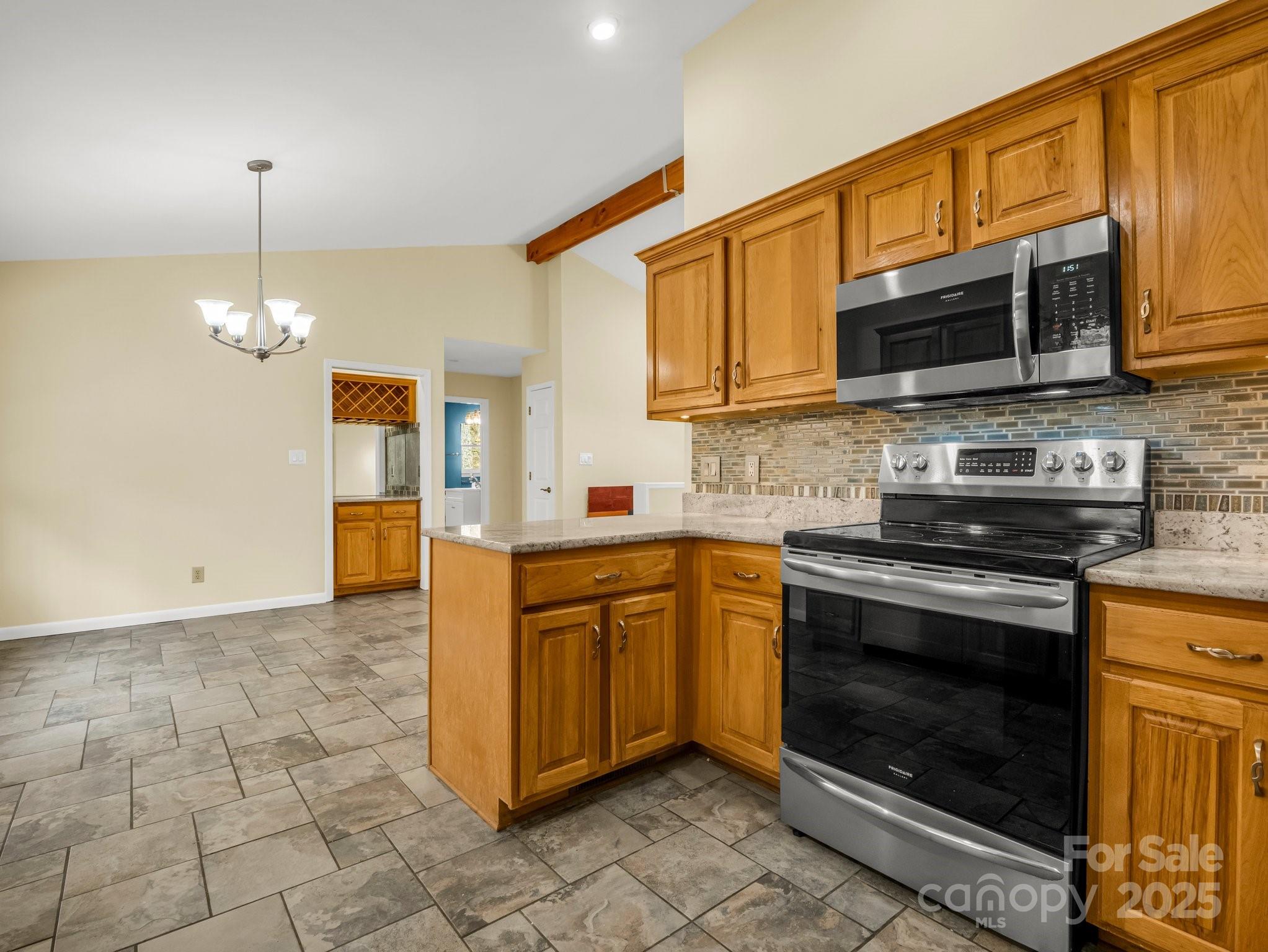 1116 High Vista Drive Mills River, NC 28759 - Photo 17 of 40 a kitchen with stainless steel appliances granite countertop a stove top oven a sink a counter space and cabinets