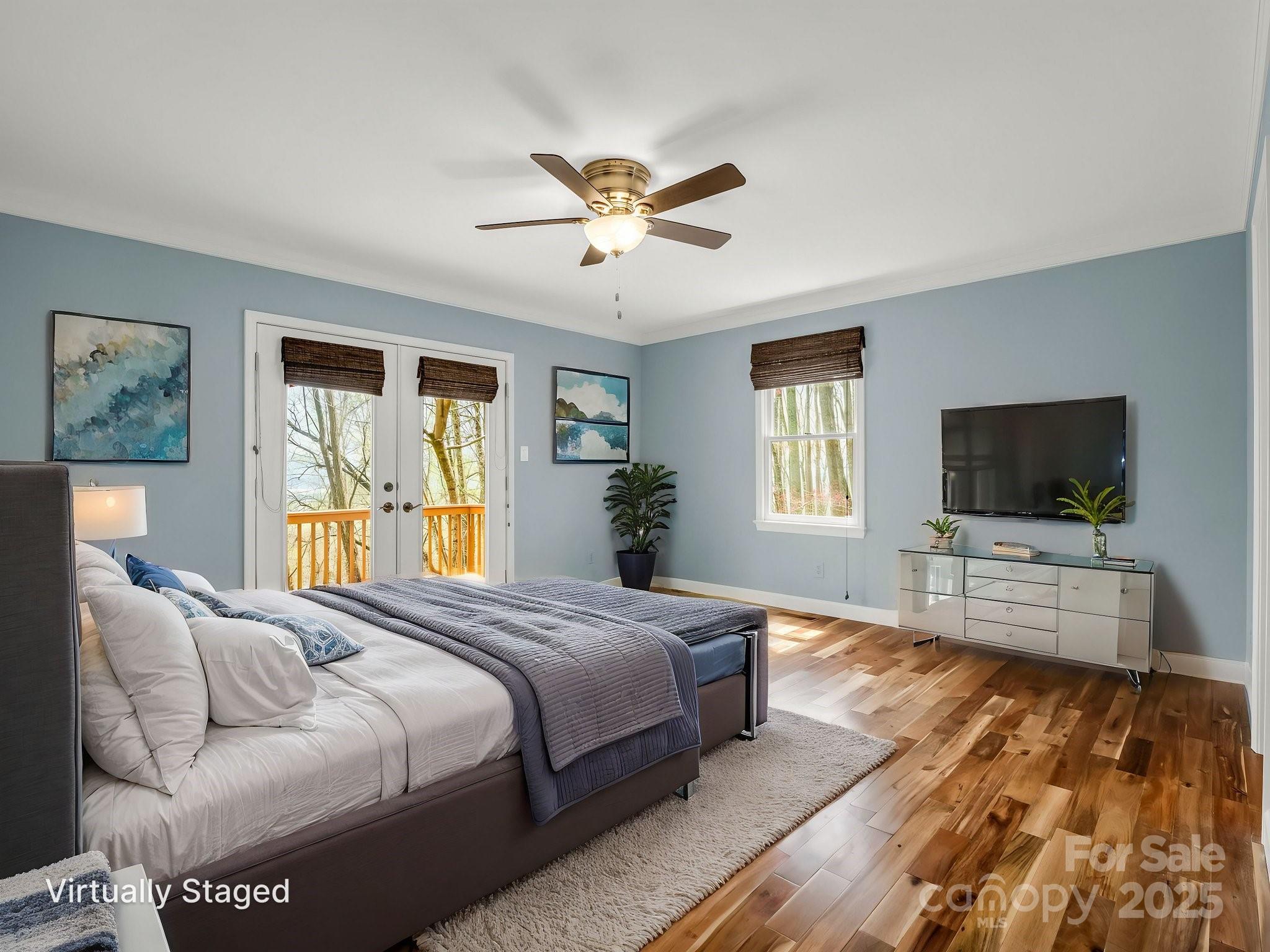 1116 High Vista Drive Mills River, NC 28759 - Photo 18 of 40 a bedroom with a bed and a flat screen tv