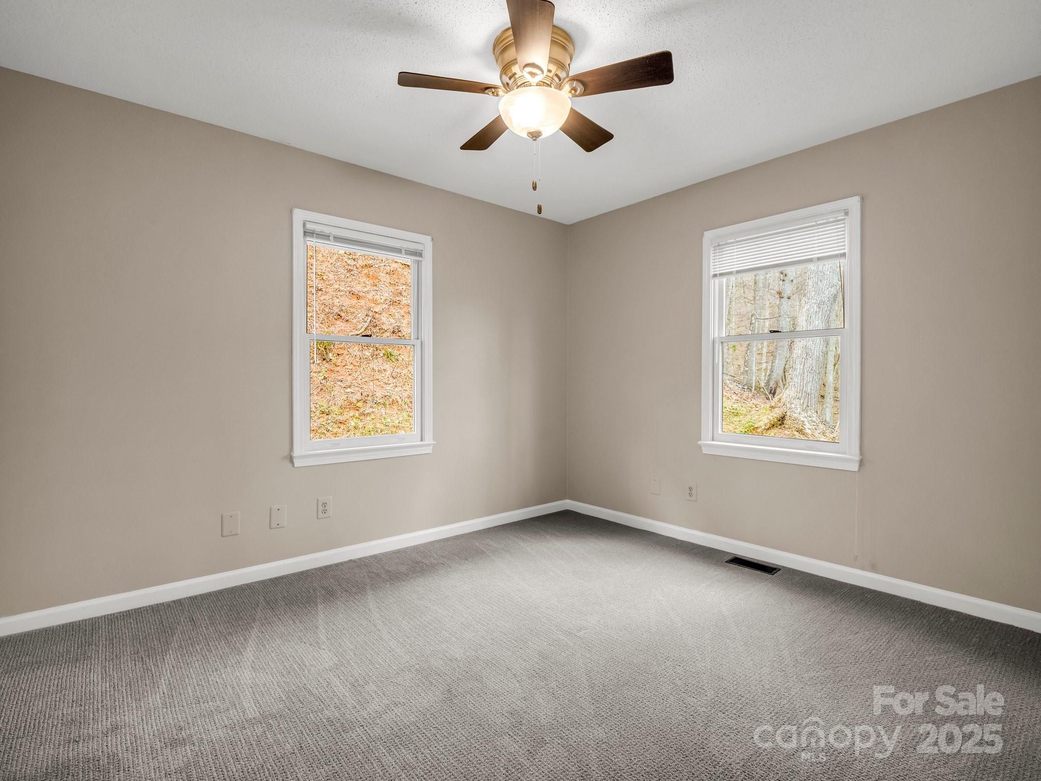 1116 High Vista Drive Mills River, NC 28759 - Photo 23 of 40 an empty room with a window and a fan