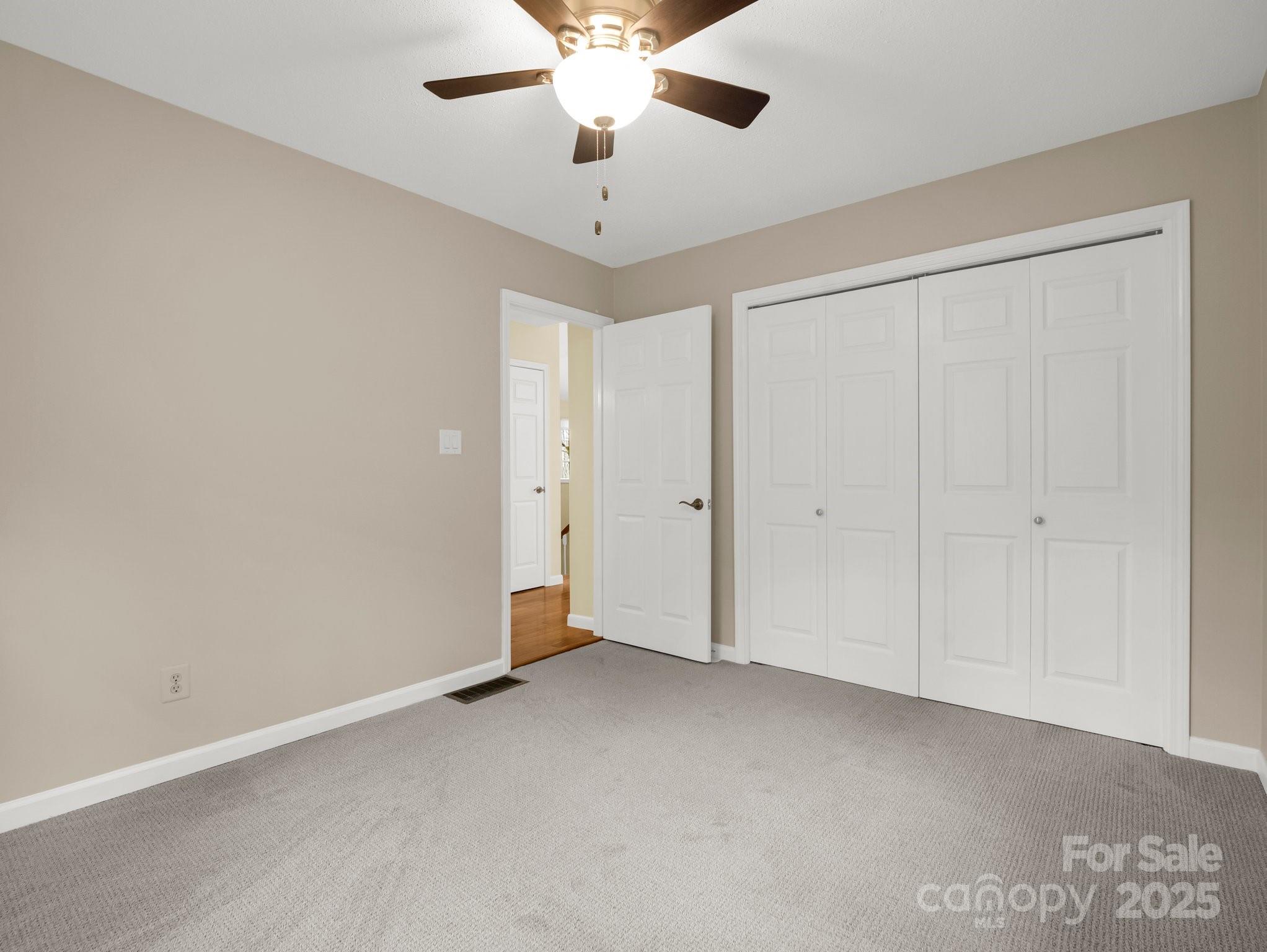 1116 High Vista Drive Mills River, NC 28759 - Photo 26 of 40 an empty room with a ceiling fan and a window