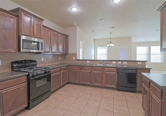 a kitchen with a sink cabinets and stainless steel appliances
