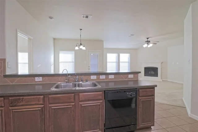 a sink with a granite counter top a stove and a sink