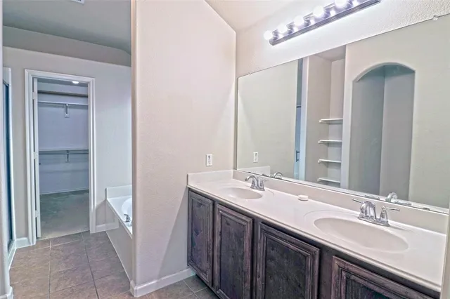 a bathroom with a double vanity sink and a mirror