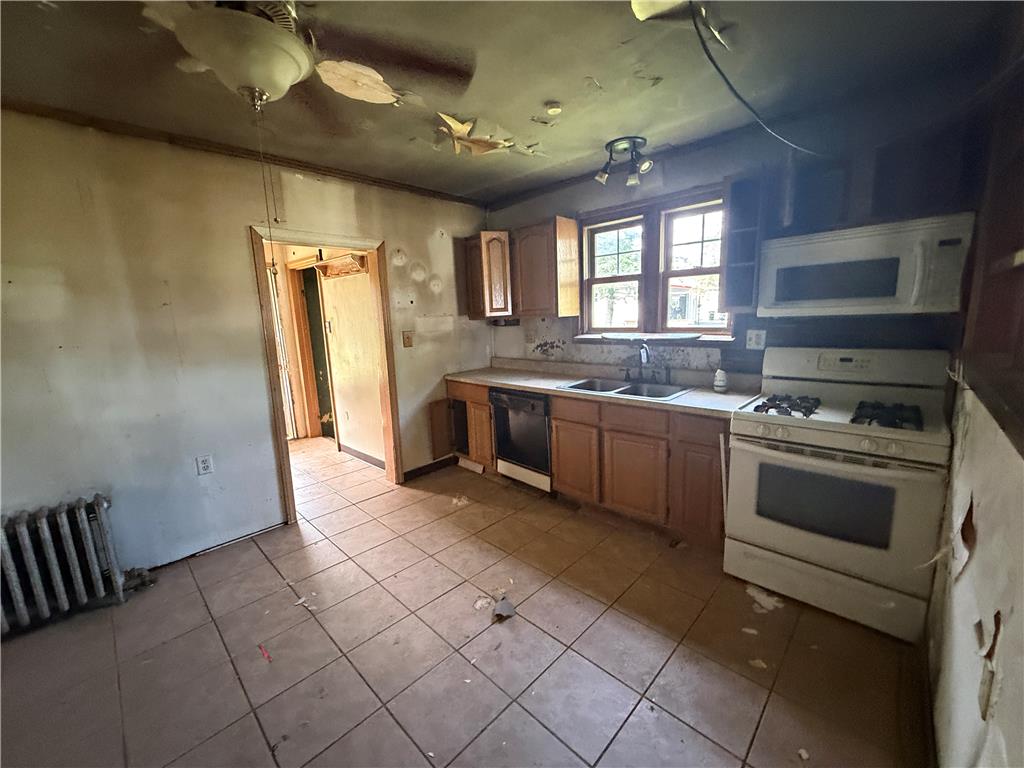 3051 Keystone Street Bethlehem, PA 18020 - Photo 10 of 18 A promising kitchen awaiting transformation, featuring essential appliances and a functional layout.