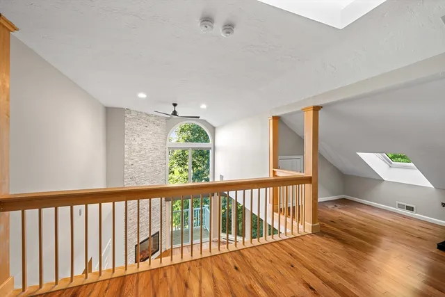 a view of hallway with wooden floor