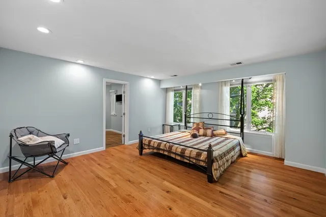 a living room with a bed and a window
