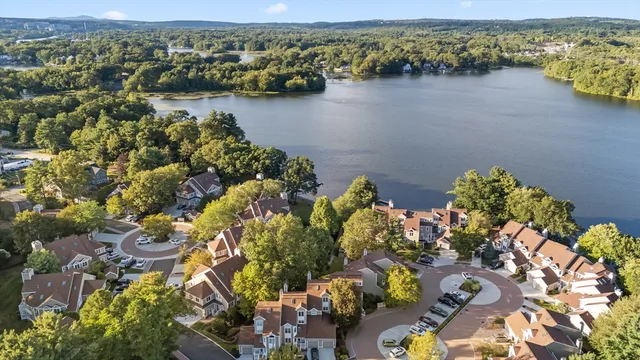 an aerial view of a houses with a lake view