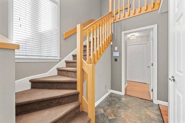 a view of entryway bedroom and hall with wooden floor