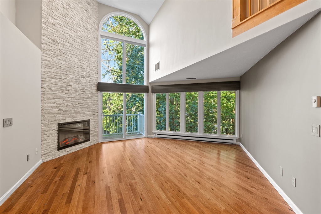 48 Pointe Rok Drive, Unit 48 Worcester, MA 01604 - Photo 8 of 42 a view of an empty room with a window and wooden floor