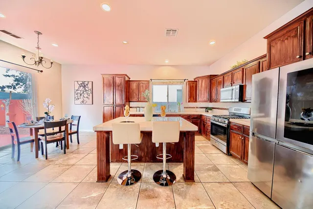 a large kitchen with a table and chairs