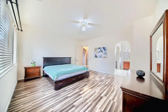 a bedroom with furniture and wooden floor