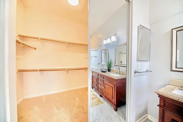 a bathroom with a sink mirror and a shower