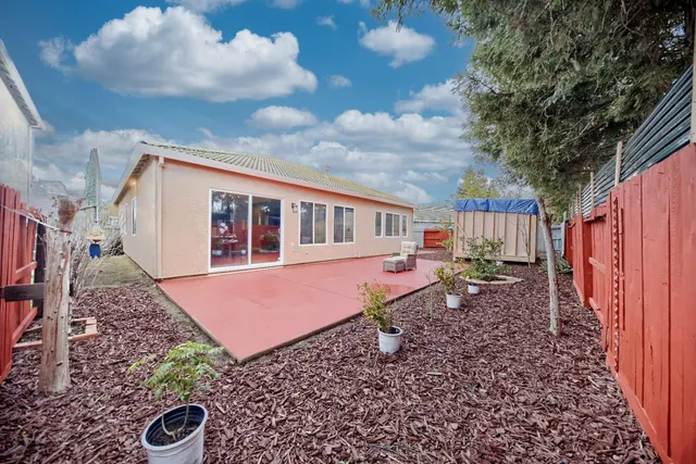 a backyard of a house with yard fire pit barbeque oven and outdoor seating