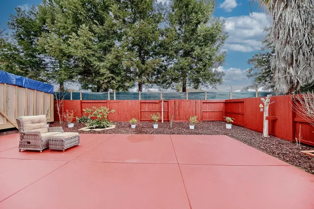 a backyard of a house with barbeque oven
