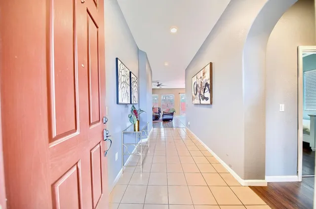 a view of a hallway with furniture and a window