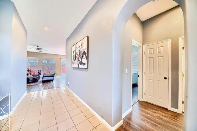 a view of a hallway with wooden floor and furniture