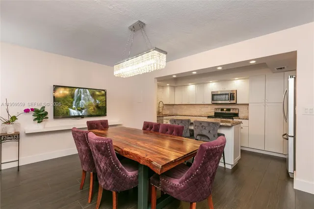 a dining room with furniture and wooden floor