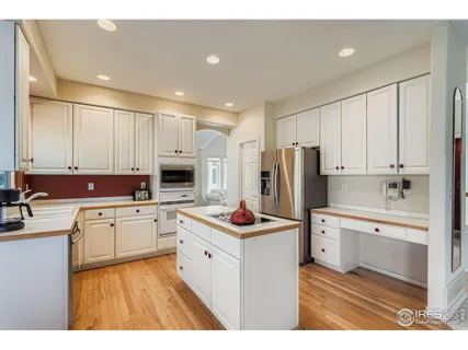 a kitchen with wooden cabinets and stainless steel appliances