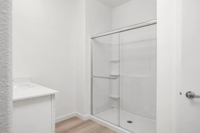 a bathroom with a glass shower door