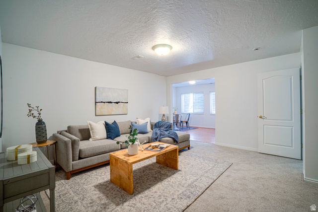 1433 Forge Way Draper, UT 84020 - Photo 19 of 29 Carpeted living area featuring a neutral color palette, recessed lighting, and a white paneled interior door