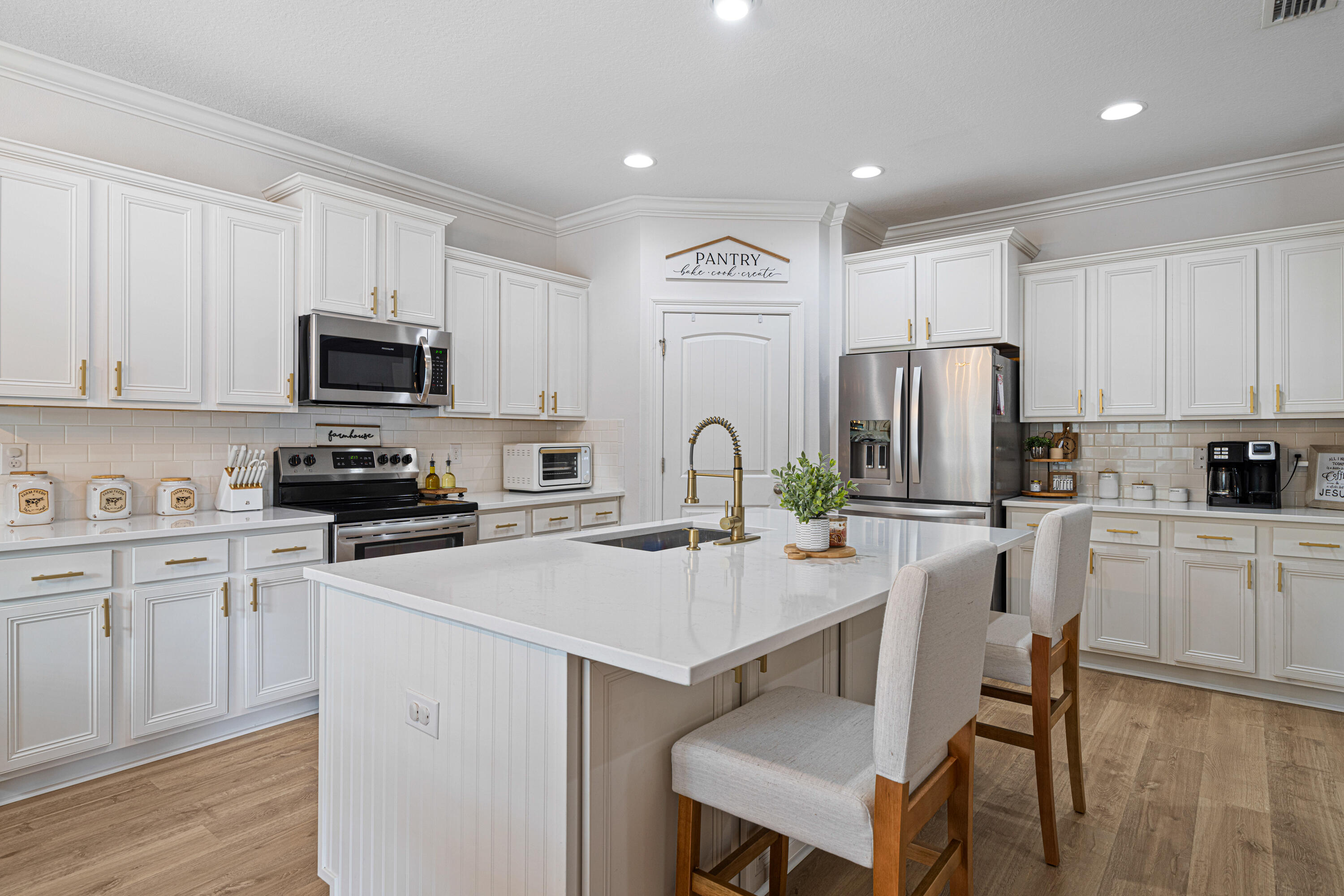 52 Conner Circle, Unit LOT 164 Santa Rosa Beach, FL 32459 - Photo 11 of 50 a kitchen with refrigerator a stove a sink and chairs