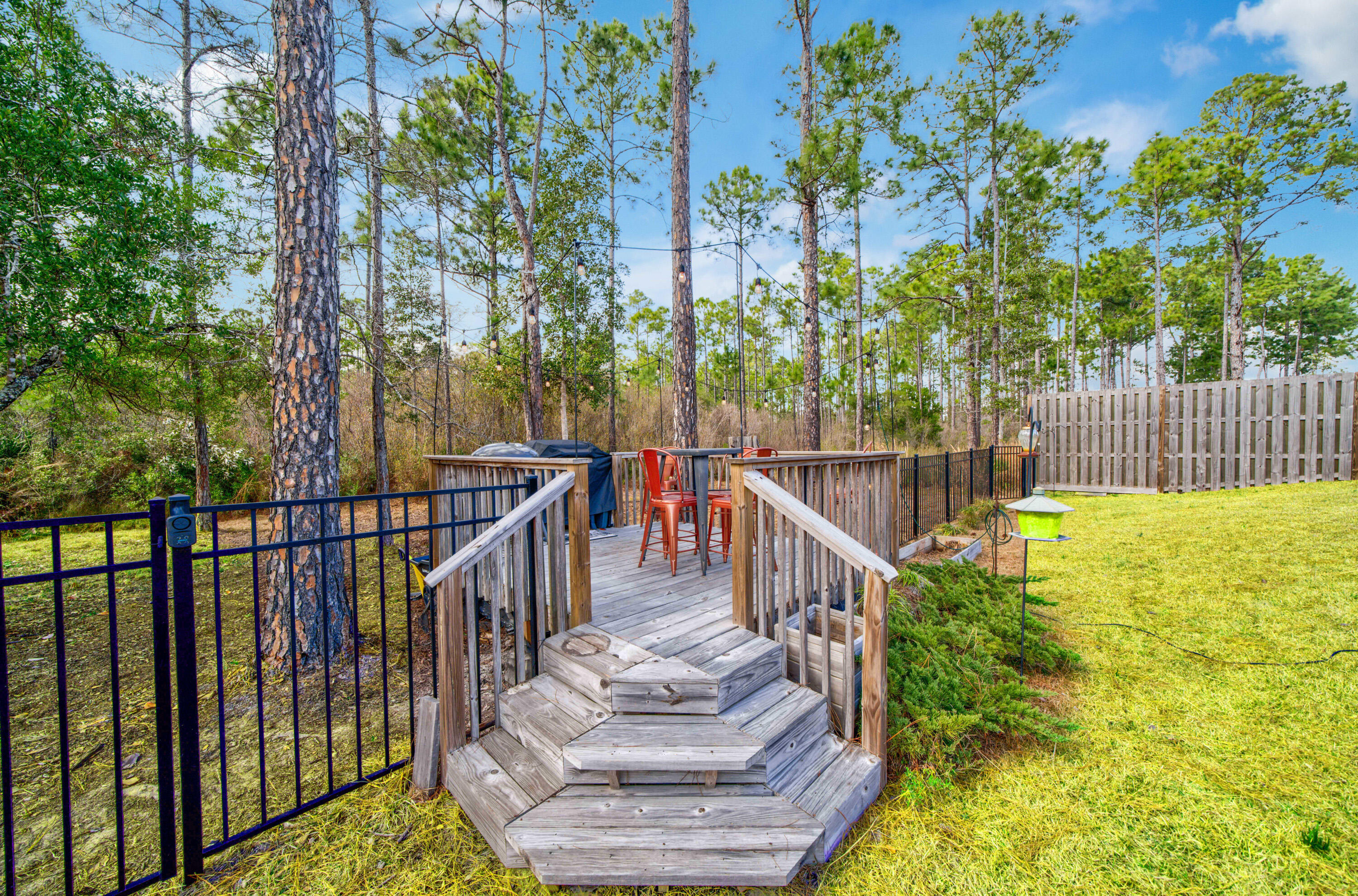 52 Conner Circle, Unit LOT 164 Santa Rosa Beach, FL 32459 - Photo 46 of 50 a balcony with tall trees