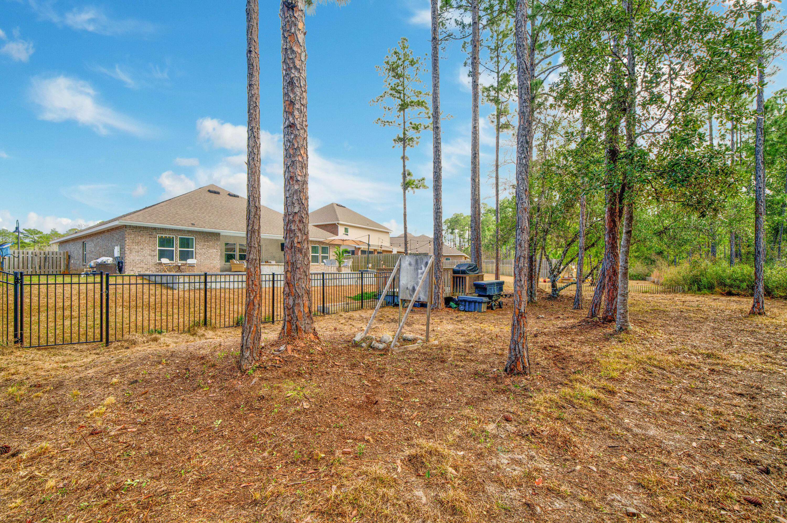 52 Conner Circle, Unit LOT 164 Santa Rosa Beach, FL 32459 - Photo 7 of 50 a row of palm trees and a yard with wooden fence